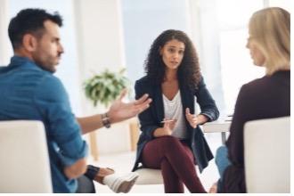 Three people sitting in mediation