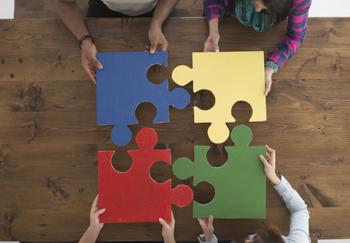 Photo of people putting puzzle together