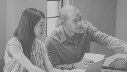 man and woman looking at laptop screen