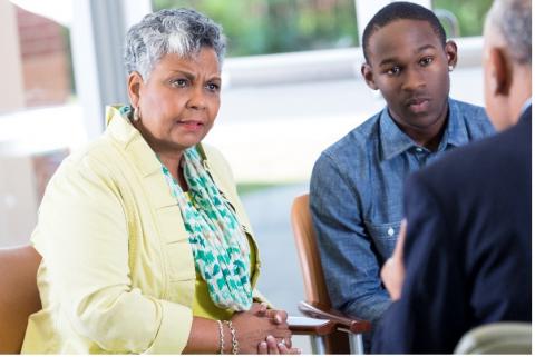 Parent and Son having a meeting with someone