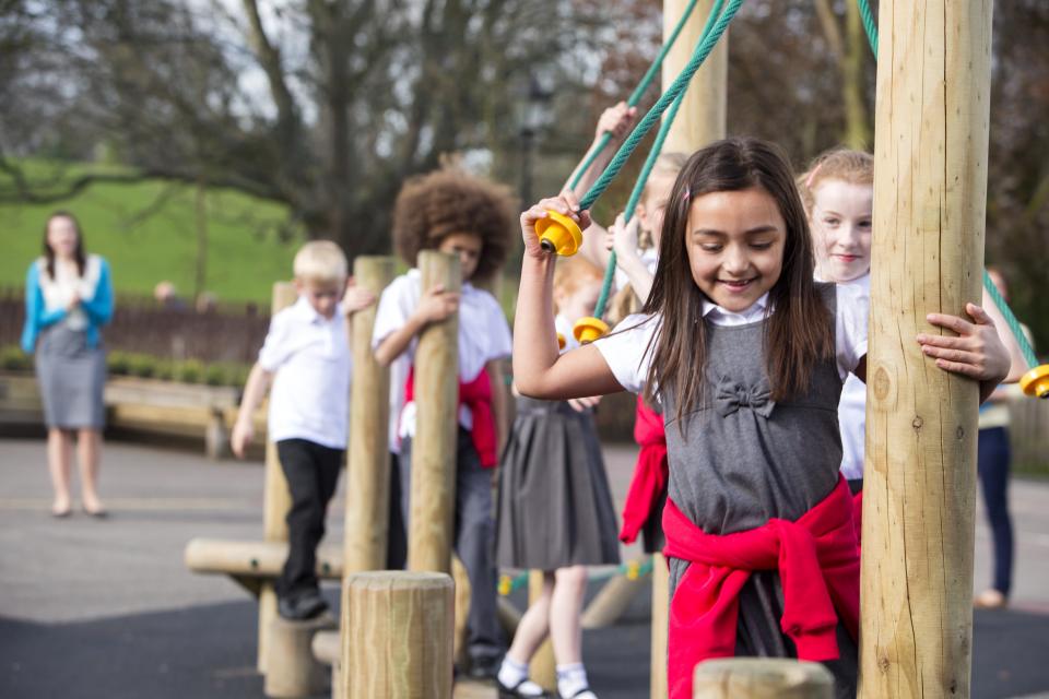 Elementary girl on school jungle gym